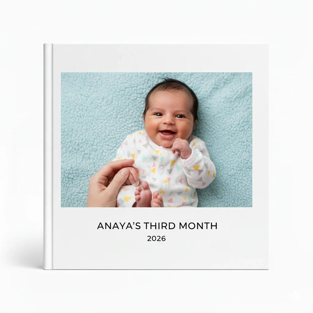Personalized baby photo journal cover with smiling infant, text 'Anaya's Third Month 2026' from White Pebble