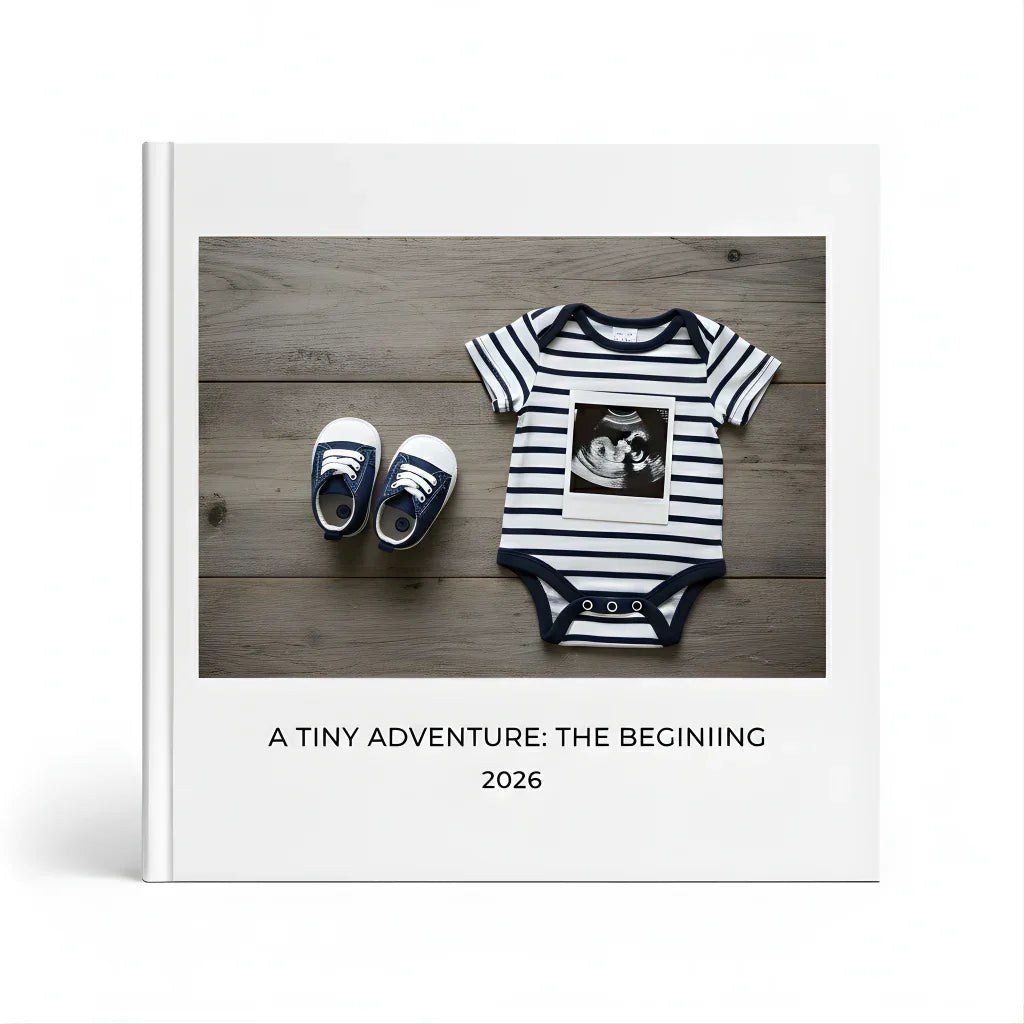 Baby photo book cover with striped onesie, baby shoes, ultrasound photo, and 'A Tiny Adventure: The Beginning 2026' title, from White Pebble premium keepsakes.